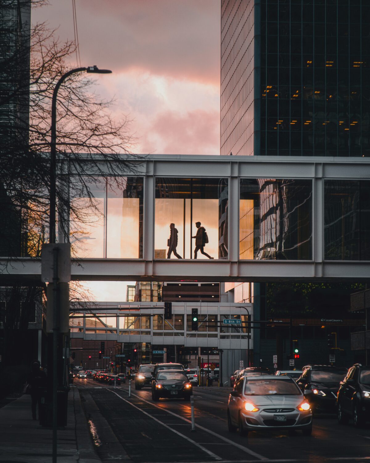 People walking through skywalk in city