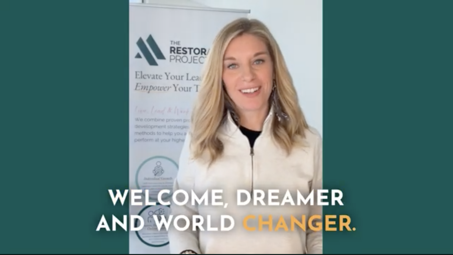 Lindsay Leahy stands in front of The Restoration Project banner