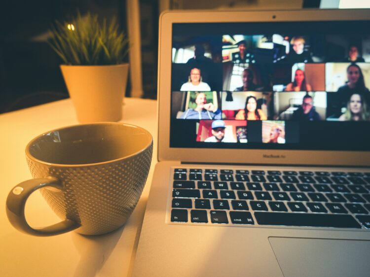 Virtual Zoom meeting with coffee cup in the foreground