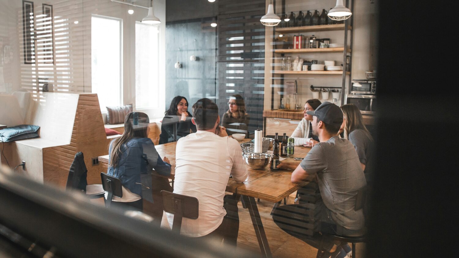 Individuals gather around a table engaged in conversation