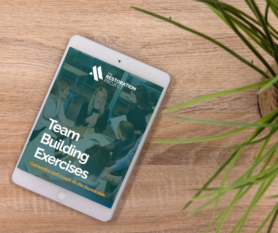 Team Building Exercises Digital product cover pictured on an ipad as it lays on a table with a plant nearby